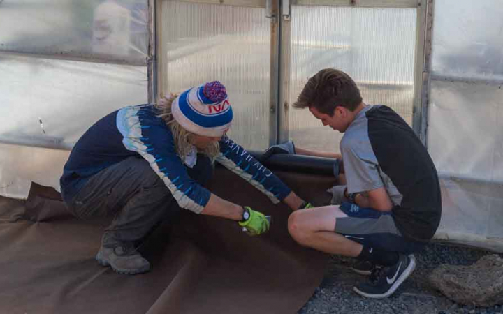 two teens engaged in a service project with outward bound